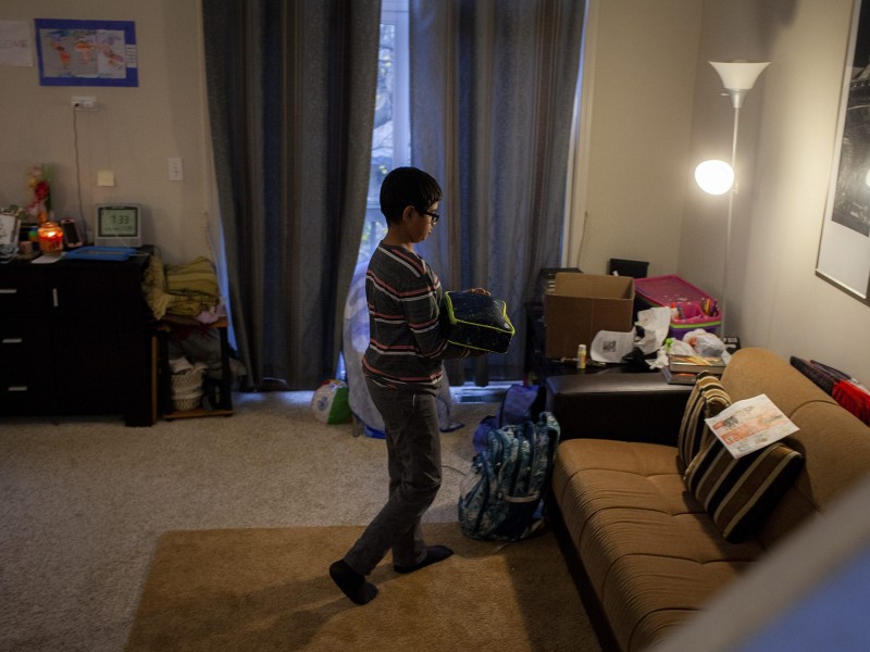 Yasir Syed, 12, puts his lunch in his backpack before leaving for school from his home in Glendale Heights, Ill., Nov. 11, 2022. Syed’s mother packed him a halal meal of macaroni and cheese and pineapple. Photo by Michelle Kanaar/Borderless Magazine