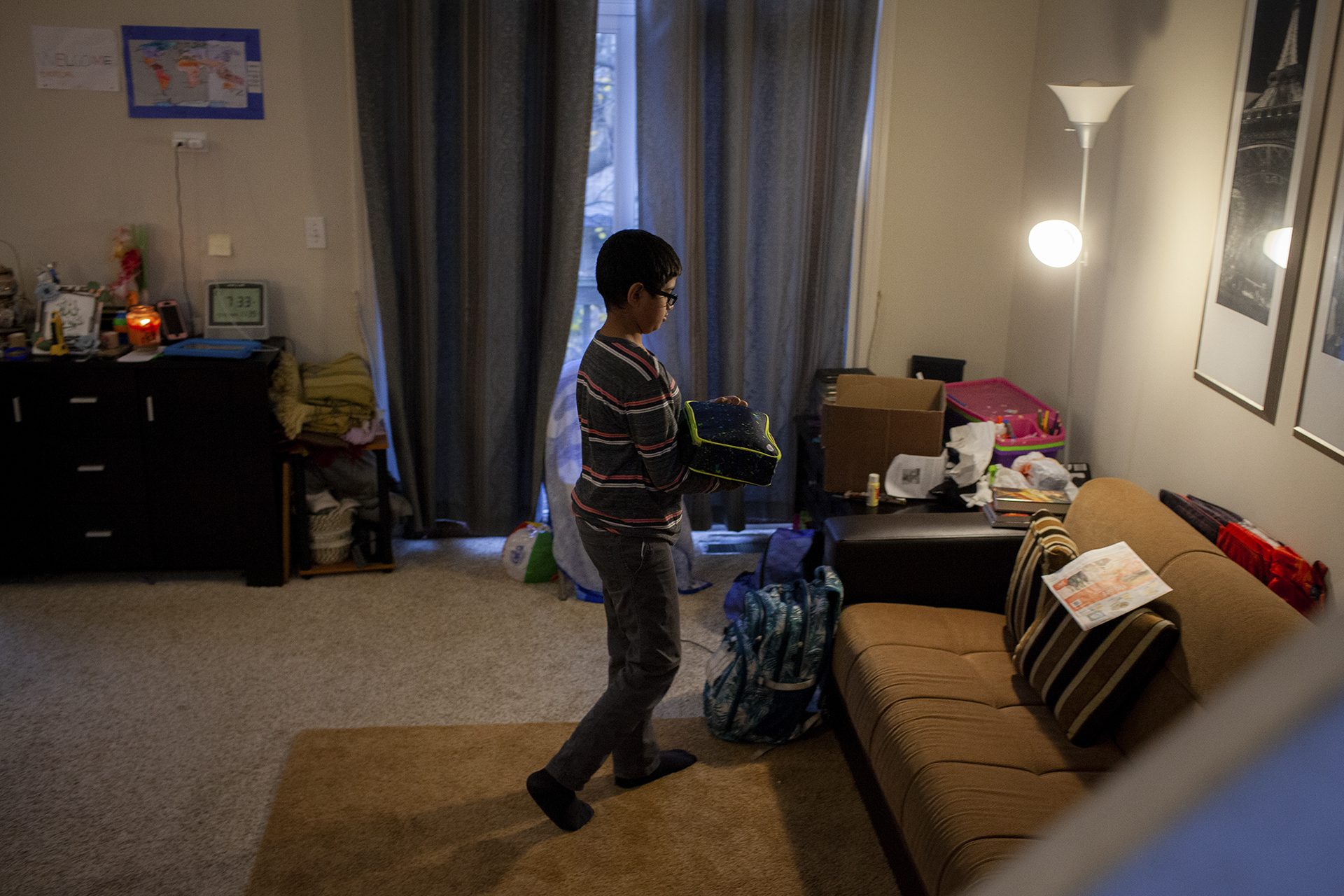 Yasir Syed, 12, puts his lunch in his backpack before leaving for school from his home in Glendale Heights, Ill., Nov. 11, 2022. Syed’s mother packed him a halal meal of macaroni and cheese and pineapple. Photo by Michelle Kanaar/Borderless Magazine