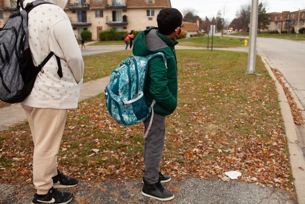 Yasir Syed, 12, waits for his bus to Hadley Junior High School from his home in Glendale Heights, Ill., Nov. 11, 2022. Photo by Michelle Kanaar/Borderless Magazine